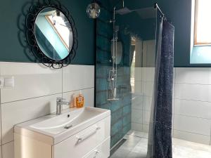 a bathroom with a sink and a shower with a mirror at Malanówka II Radęcin in Radęcin +39 photos