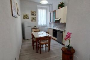 a kitchen with a table and chairs in a room at Cozy Home Away from Home in Tarquinia