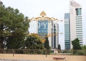 a sign for the calgary coliseum with buildings in the background at Executive Royal Garden in Islamabad
