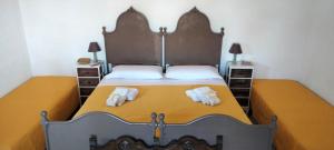 a bedroom with a bed with two towels on it at La Noria in Marsala