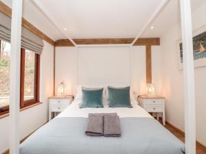a bedroom with a large bed with two night stands at Beech Barn The Rookery in Kingsbridge