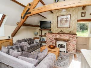 a living room with couches and a fireplace at The Cheese Loft in Carmarthen