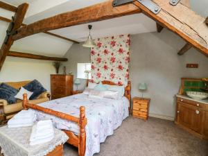 a bedroom with a bed with a wooden frame at The Cheese Loft in Carmarthen