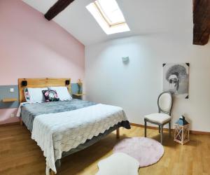a bedroom with a bed and a chair at Chambres d'hôtes - Les Varennes in Saint-Georges-de-Reneins +10 photos