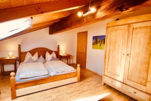 a bedroom with a wooden bed with white pillows at Landurlaub bei Familie Haug in Freyung