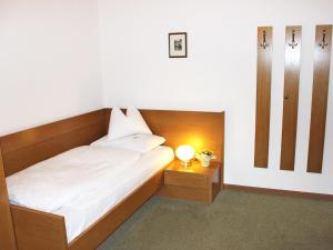 a bedroom with a bed with a light on it at Garni An der Leit in Lagundo
