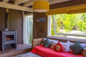 a living room with a couch and a fireplace at Chapa Pituca Boutique in San Martín de los Andes