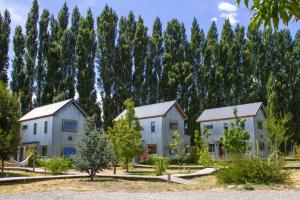 three houses in front of a forest of trees at Chapa Pituca Boutique in San Martín de los Andes