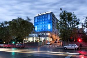 a blue building on a city street at night at Zenit Conde de Orgaz in Madrid