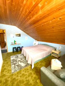 a bedroom with a bed and a couch in a room at Casa Erceg Amor vincit Omnia in Skradin