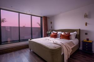 ロンドンにあるThe Luxury Fulham Townhouseのベッドルーム1室(ベッド1台、大きな窓付)