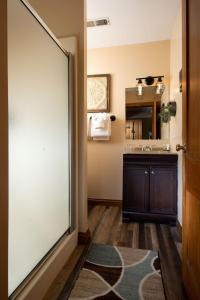 a bathroom with a large sliding door and a sink at Riverboat Suites in Galena