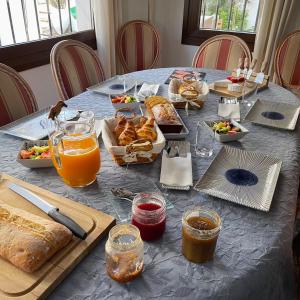 una mesa azul con comida, zumo de naranja y pan en Terra Aloé, en Torremolinos