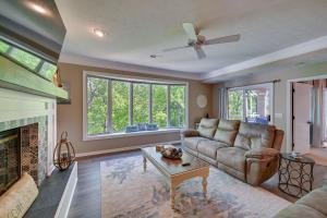 a living room with a couch and a fireplace at Lake Keowee Condo Resort Pools and Lake Access! in Salem