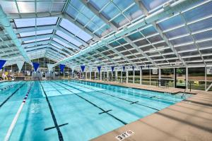 a large swimming pool with a large ceiling at Lake Keowee Condo Resort Pools and Lake Access! in Salem