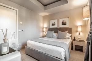 a bedroom with a large bed and a bathroom at Villa Grey in Forte dei Marmi