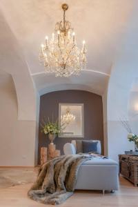 a bedroom with a bed and a chandelier at PASSAU mittendrin in Passau
