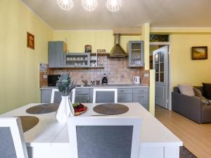 a kitchen and living room with a table and a couch at VisitZakopane - Stone Apartment in Zakopane