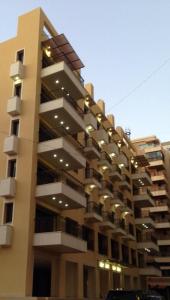 a large building with balconies and lights on it at Hanno Residence in Soûr