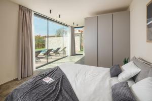 Postel nebo postele na pokoji v ubytování Design Villa Palmeta