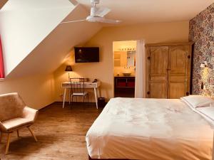 a bedroom with a bed and a chair and a desk at Hotel Het Heilig Genot in Westvleteren