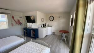 a bedroom with a bed and a desk with a tv at 2 Min Walk To The Beach-all Renovated Studio #4 in Fort Lauderdale