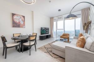 a living room with a couch and a table at The bright One Residence by Suiteable Interiors in Dubai