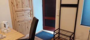 a room with a closet with a chair and a door at Gaukshof in Selfoss