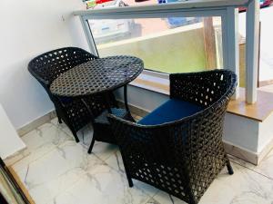 duas cadeiras e uma mesa em frente a uma janela em بورتو سعيد غرفه وصاله ارضى em `Ezbet Shalabi el-Rûdi