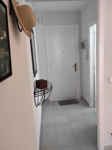 a hallway with a white floor and a white door at Apartmento Duplex in S'agaro
