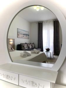 a bedroom with a bed and a large mirror at Apartmens Xhenis Lux in Ulcinj