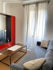 a living room with a couch and a coffee table at Paolina Home in La Spezia