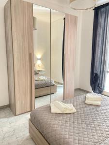 a bedroom with two beds and a mirror at Paolina Home in La Spezia