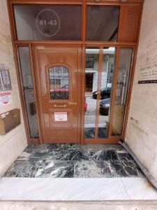 a door to a building with a sign on it at Hermes - Acropolis Residence Apartment in Athens