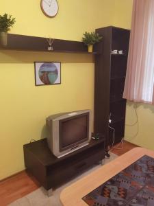a living room with a tv sitting on a table at Гарсониера in Stara Zagora
