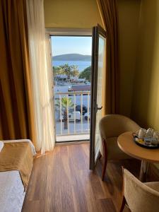 a room with a bed and a table and a balcony at EXEN BY WEEKEND in Bodrum City