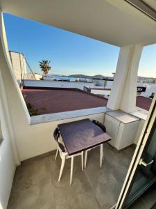 a balcony with a table and a bench on a building at EXEN BY WEEKEND in Bodrum City