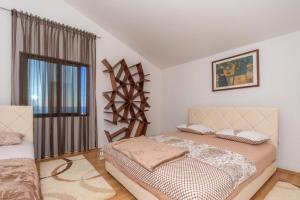 a bedroom with two beds and a window at Apartman Sara in Bar +91 photos