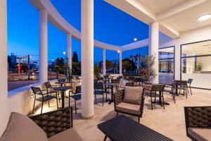 a restaurant with tables and chairs on a patio at Miramare Hotel in Zadar