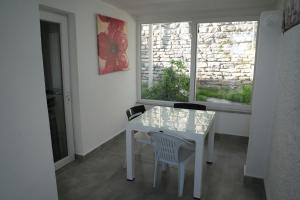 a white table and chairs in a room with a window at EXEN BY WEEKEND in Bodrum City