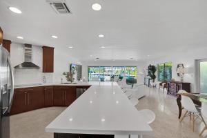 a kitchen and living room with a large white counter top at 44 Canal Home With Heated Pool & Free Dock in Fort Lauderdale