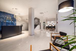 a living room with a large screen tv in a building at Miramare Hotel in Zadar