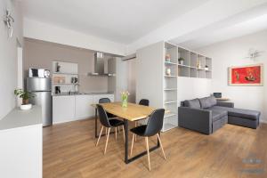 a kitchen and living room with a table and chairs at 2 Min zum Lago Maggiore, Modernes & Zentrales Apartment in Cannobio +5 photos