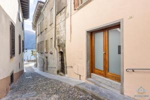 alejka z drzwiami na boku budynku w obiekcie Appartamento Piccolo Nido w mieście Cannobio