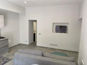 a living room with a couch and a tv on a wall at Casa Wanda - Restyled 2026 Edition Holiday Home, Ischia Center in Ischia Town
