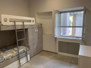 a small room with a bunk bed and a window at Casa Wanda - Restyled 2026 Edition Holiday Home, Ischia Center in Ischia Town