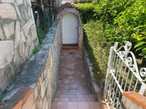 an entrance to a house with a stone wall and a gate at Casa Wanda - Restyled 2026 Edition Holiday Home, Ischia Center in Ischia Town