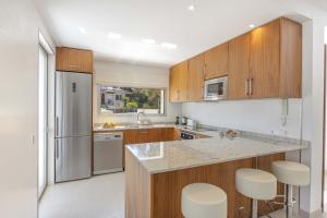 a kitchen with wooden cabinets and stainless steel appliances at Villa Cel in Muro