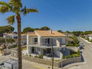 a large white house with a palm tree at Villa Cel in Muro