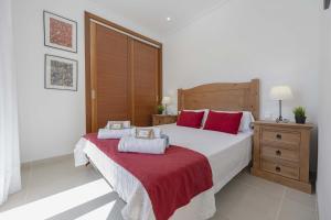 a bedroom with a large white bed with red pillows at Villa Cel in Muro +46 photos